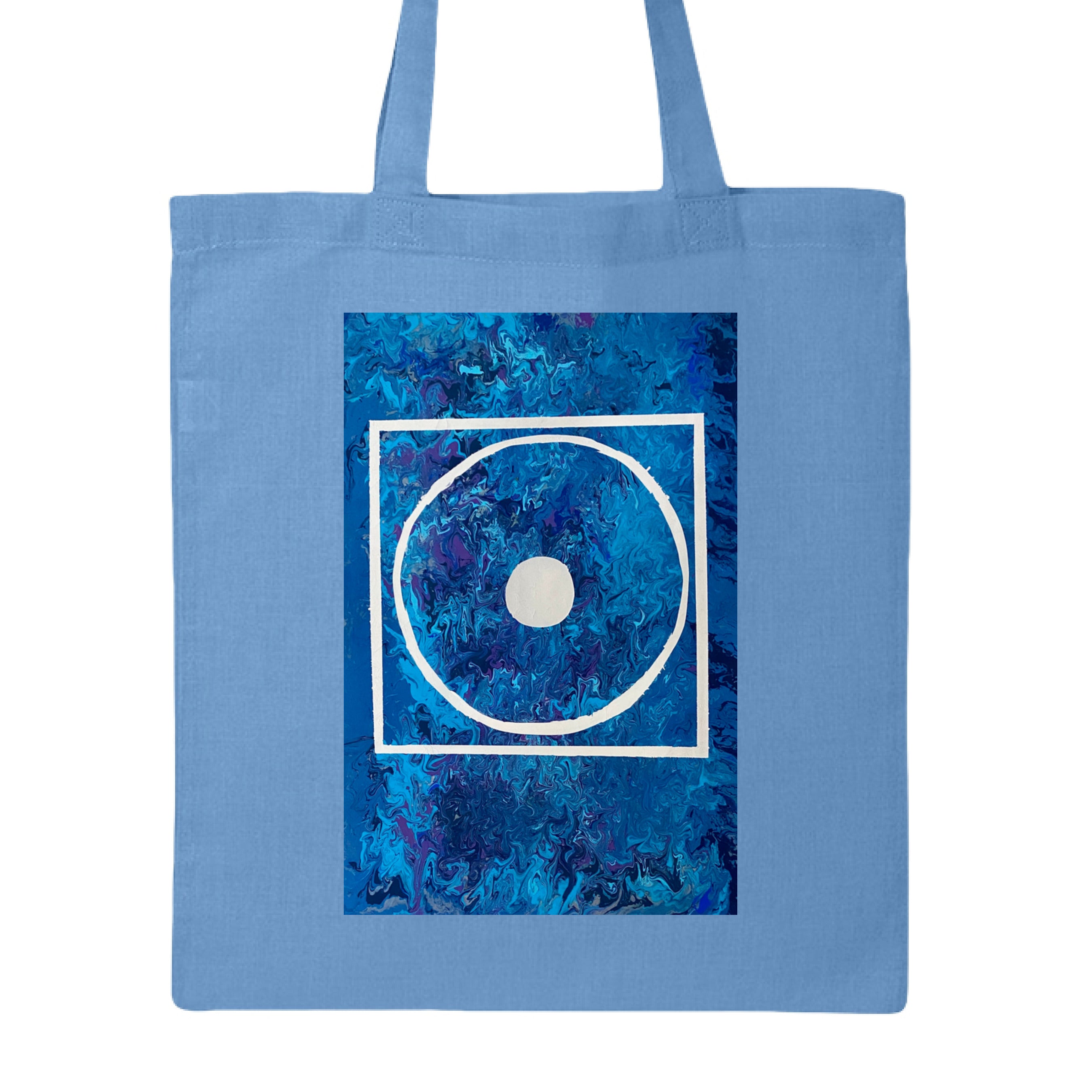 This is the Carolina Blue Big Low Canvas Tote by Storm Garden Studio. This is showcasing the front of the tote. The illustration is rectangular and has a white filled in dot, within a outlined circle, within a outlined rectangle. The background is a mix and dip of different blues. The tote is against a white background.