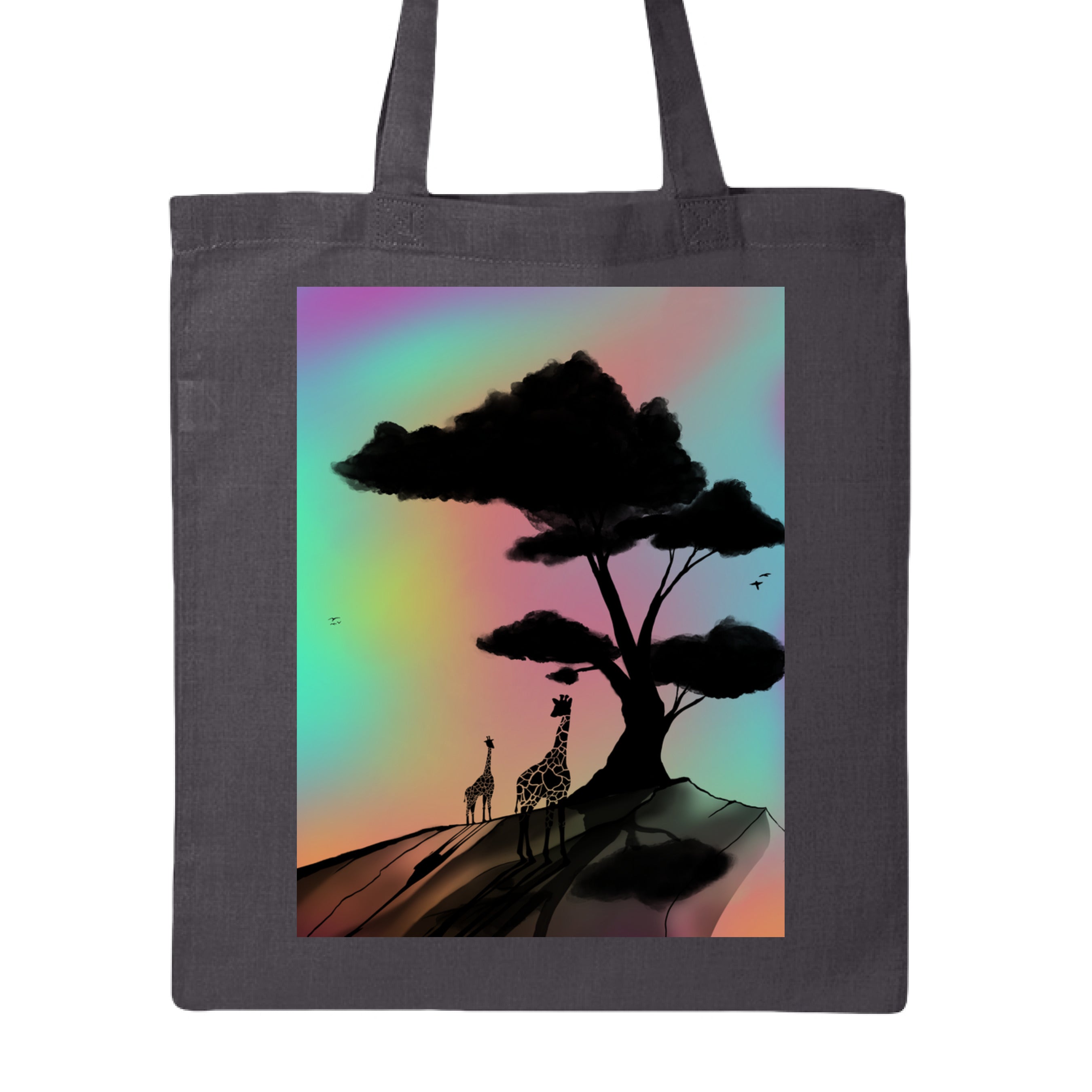 This is the Charcoal At a Glance Canvas Tote by Lee Hansheng Studios. This is showcasing the front of the tote. The illustration is a sillouhette of a large tree, two giraffes on a rocky hill. In the background are hues and gradients of green, yellow, purple, and red. The giraffes are looking towards to each other. It is against a white background.