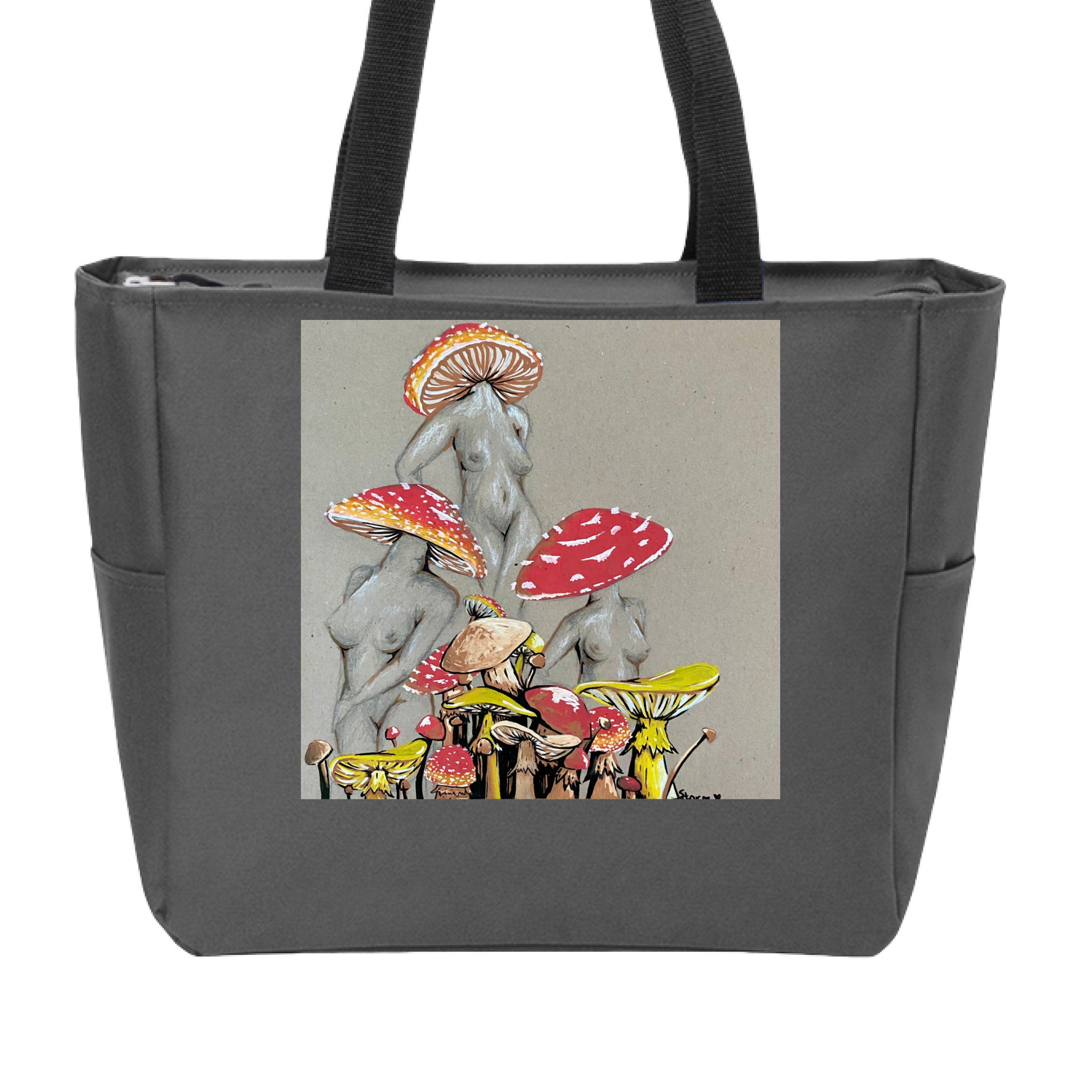 This is the Dark Charcoal Miss Amanita Zip Tote by Storm Garden Studio. This is showcasing the front. This illustration is on tan/grey background. There are three fusions of female human anatomy and mushroom fungi. Their heads are different styles of mushrooms, bodies are a gray/white outlined in brown. Below are different mushrooms and shapes with a mix of tan, red, white and yellow colors. The tote handles are black. It is against a white background.