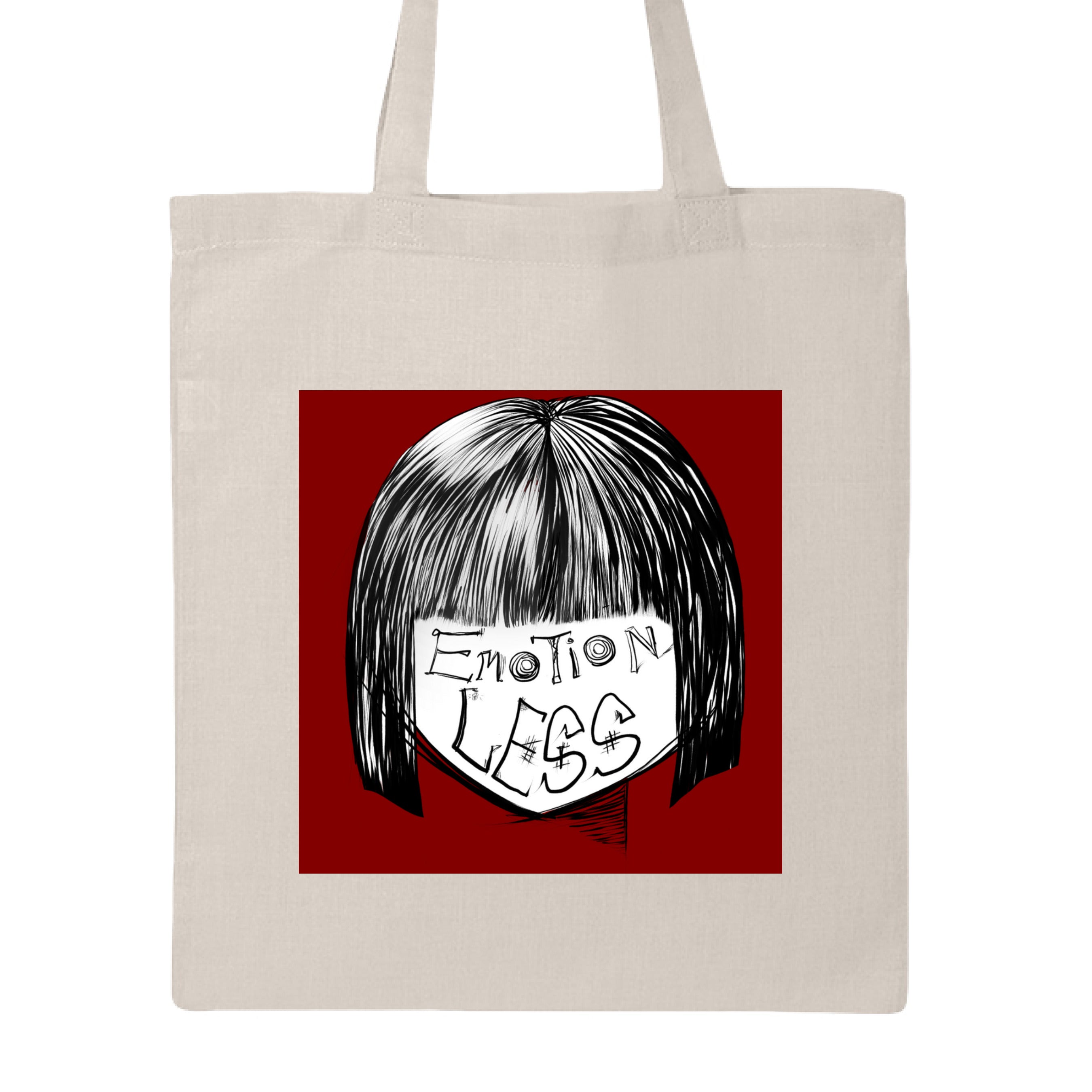 This is the Natural Emotionless Canvas Tote by Lee Hansheng Studios. This is showcasing the front. This illustration is squared and features exploring themes of identity, silence, and hidden emotion through stark contrasts of black, white, and deep red. There are the words,"Emotionless" written in black on the face. Hair is white and black and the background is a dark deep red. The tote is against a white background.