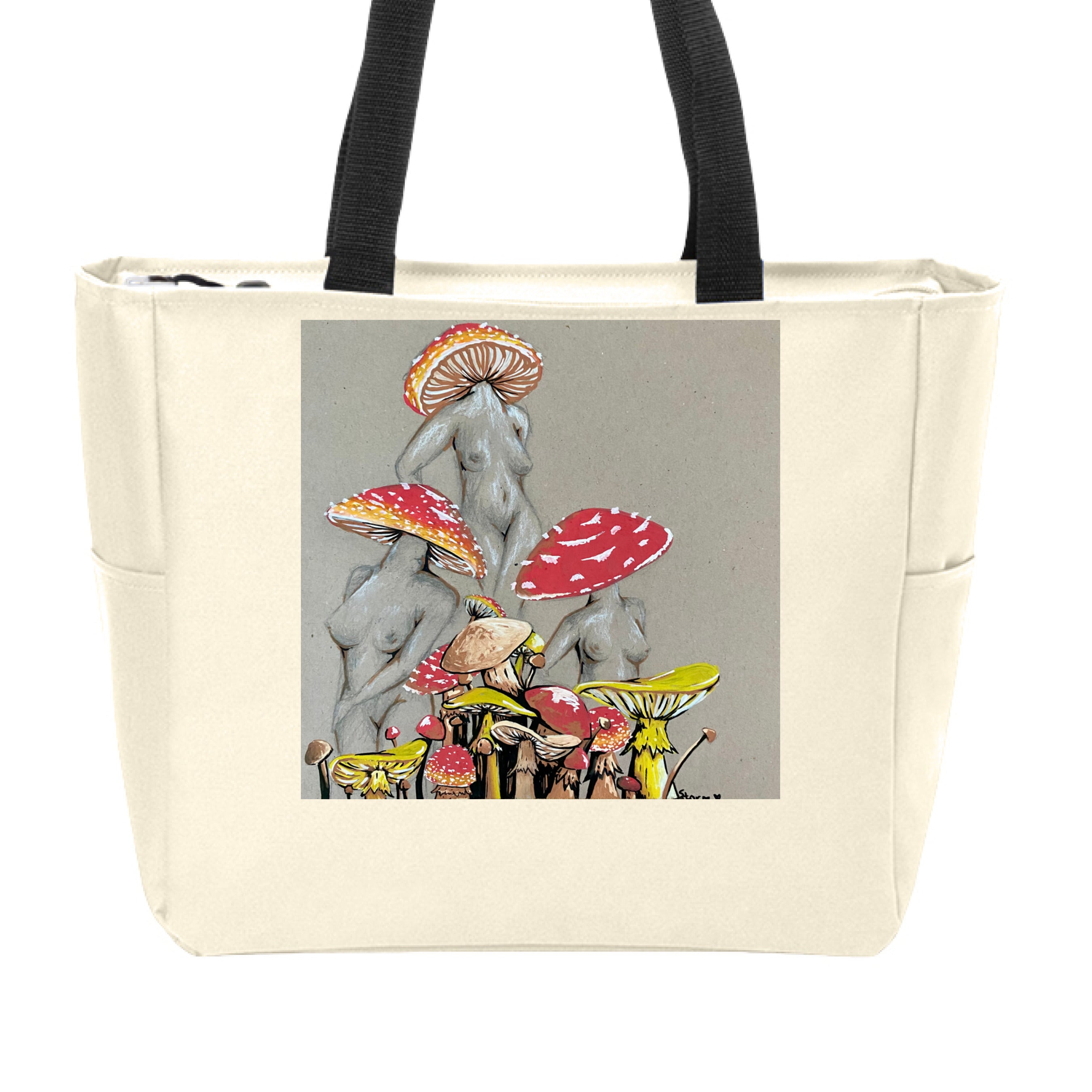 This is the Stone Miss Amanita Zip Tote by Storm Garden Studio. This is showcasing the front. This illustration is on tan/grey background. There are three fusions of female human anatomy and mushroom fungi. Their heads are different styles of mushrooms, bodies are a gray/white outlined in brown. Below are different mushrooms and shapes with a mix of tan, red, white and yellow colors. The tote handles are black. It is against a white background.