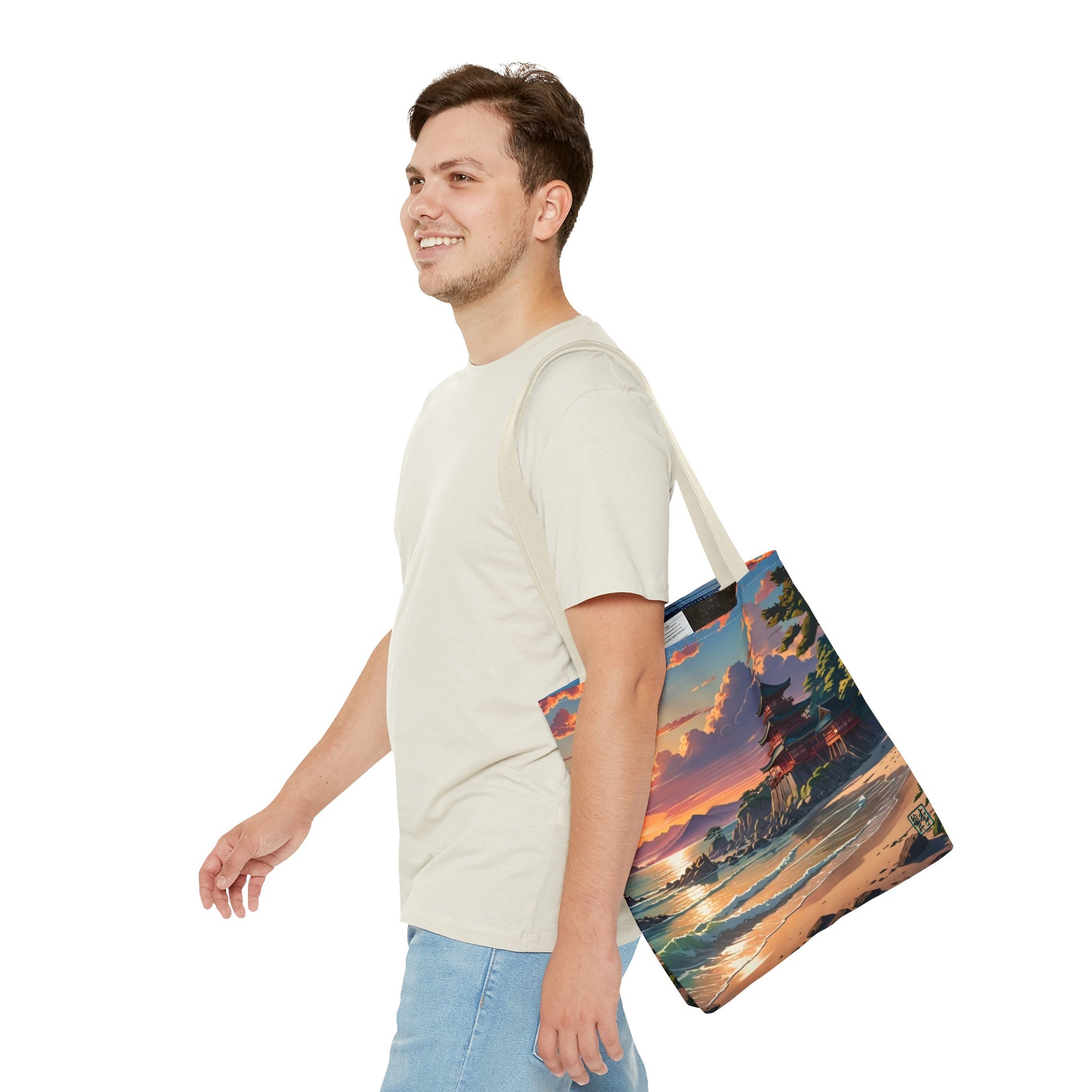 This is the Beige 13" x 13" Temple of Peace All-over Print Tote Bag by Lee Hansheng Studios.The illustration shows a setting red/orange sun above clouds,two blue roof,brown/red walled temples on the right on top of the hills,mountains,blue/white waves into sand and a forest to the right.On the bottom right corner is the logo printed in black for the studio and outlined in blue. A man walking to the left, smiling, wearing white tee, light jeans with tote hanging on his shoulder and swinging his arms.
