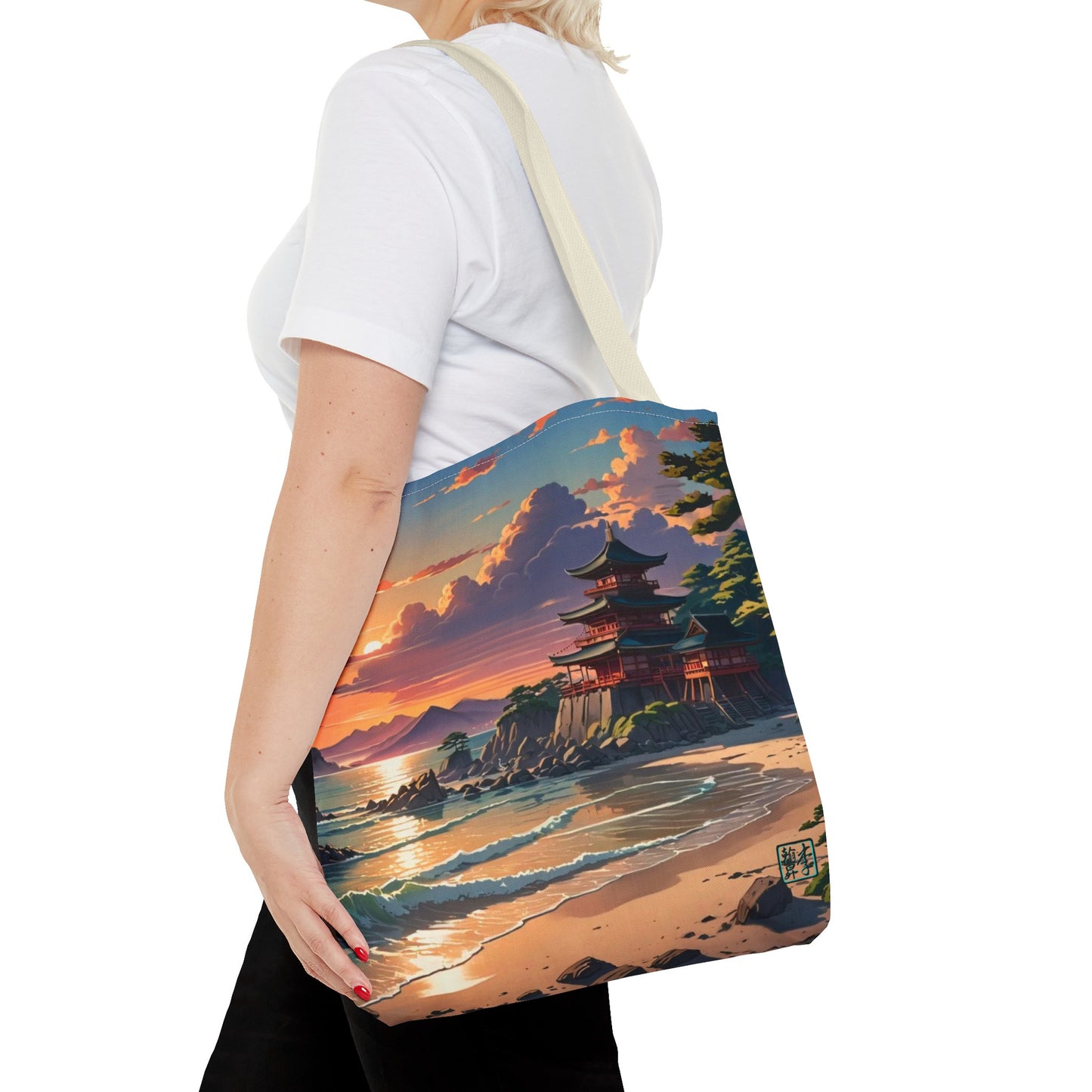 This is the Beige 16" x 16" Temple of Peace All-over Print Tote Bag by Lee Hansheng Studios.The illustration shows a setting red/orange sun above clouds,two blue roof,brown/red walled temples on the right on top of the hills,mountains,blue/white waves into sand and a forest to the right.On the bottom right corner is the logo printed in black for the studio and outlined in blue.A lady carries the tote from the shoulder,a white tee,blond short hair,her hand in the black pants pocket walking towards the left.