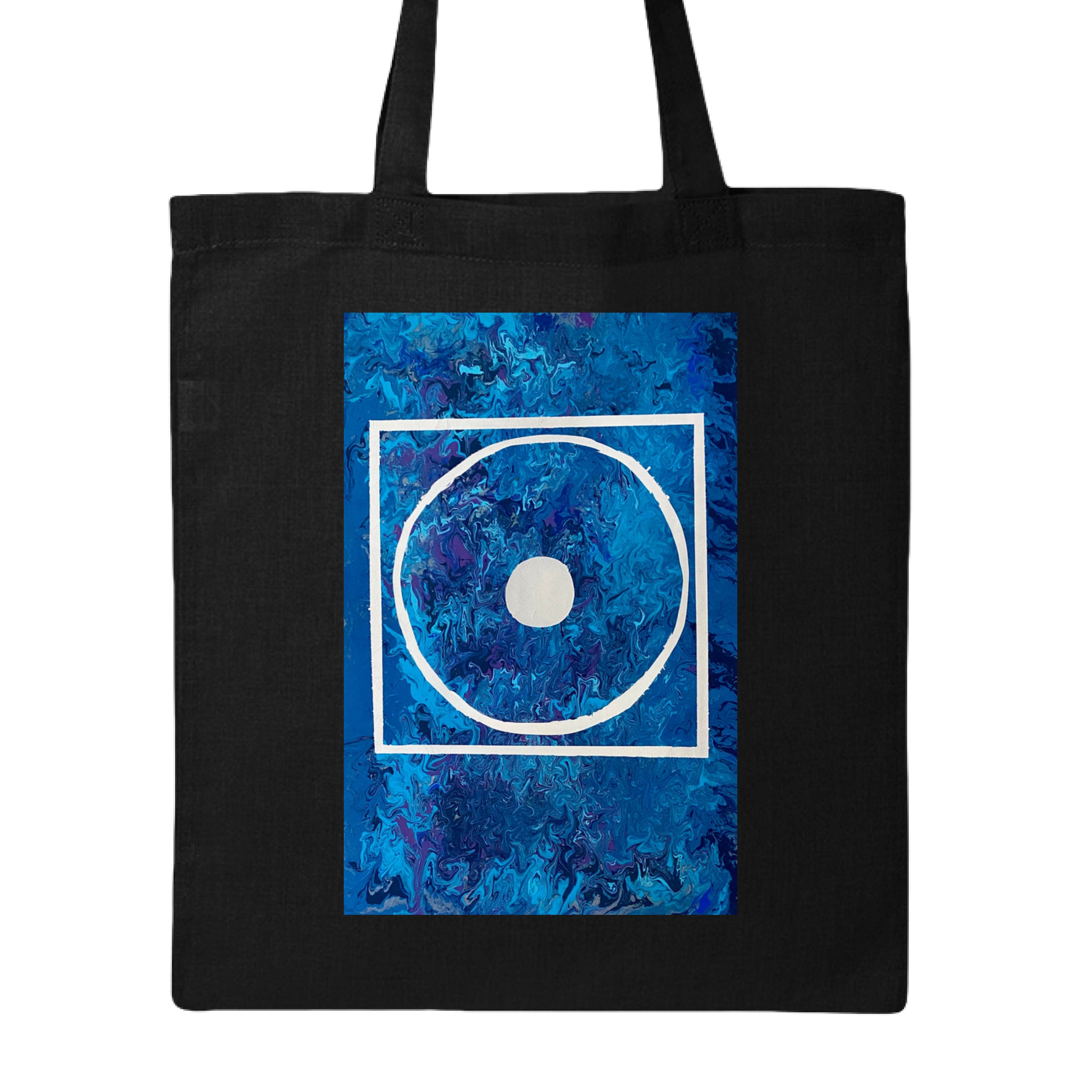 This is the Black Big Low Canvas Tote by Storm Garden Studio. This is showcasing the front of the tote. The illustration is rectangular and has a white filled in dot, within a outlined circle, within a outlined rectangle. The background is a mix and dip of different blues. The tote is against a white background.