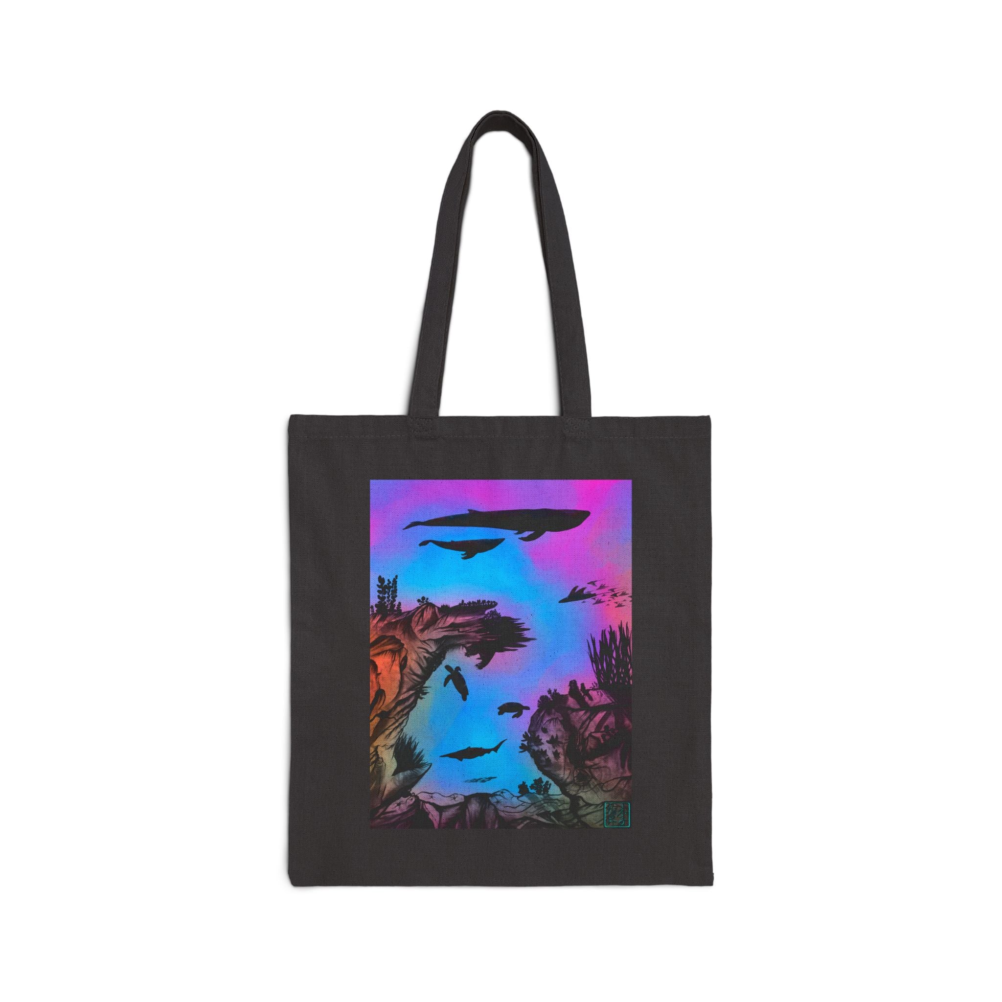 This is the Black Into the Abyss Canvas Tote by Lee Hansheng Studios.The image is from the front. The illustration is underwater seascape with aquatic plants on a marbled background.There are two blue whales,1 goblin shark,school of eagle rays,two sea turtles and a school of fish.On the bottom right corner where the front patch of the backpack there is the studio logo printed in black outlined in blue.The colors are pink,purple,blue and red/orange. It is against a white background. 