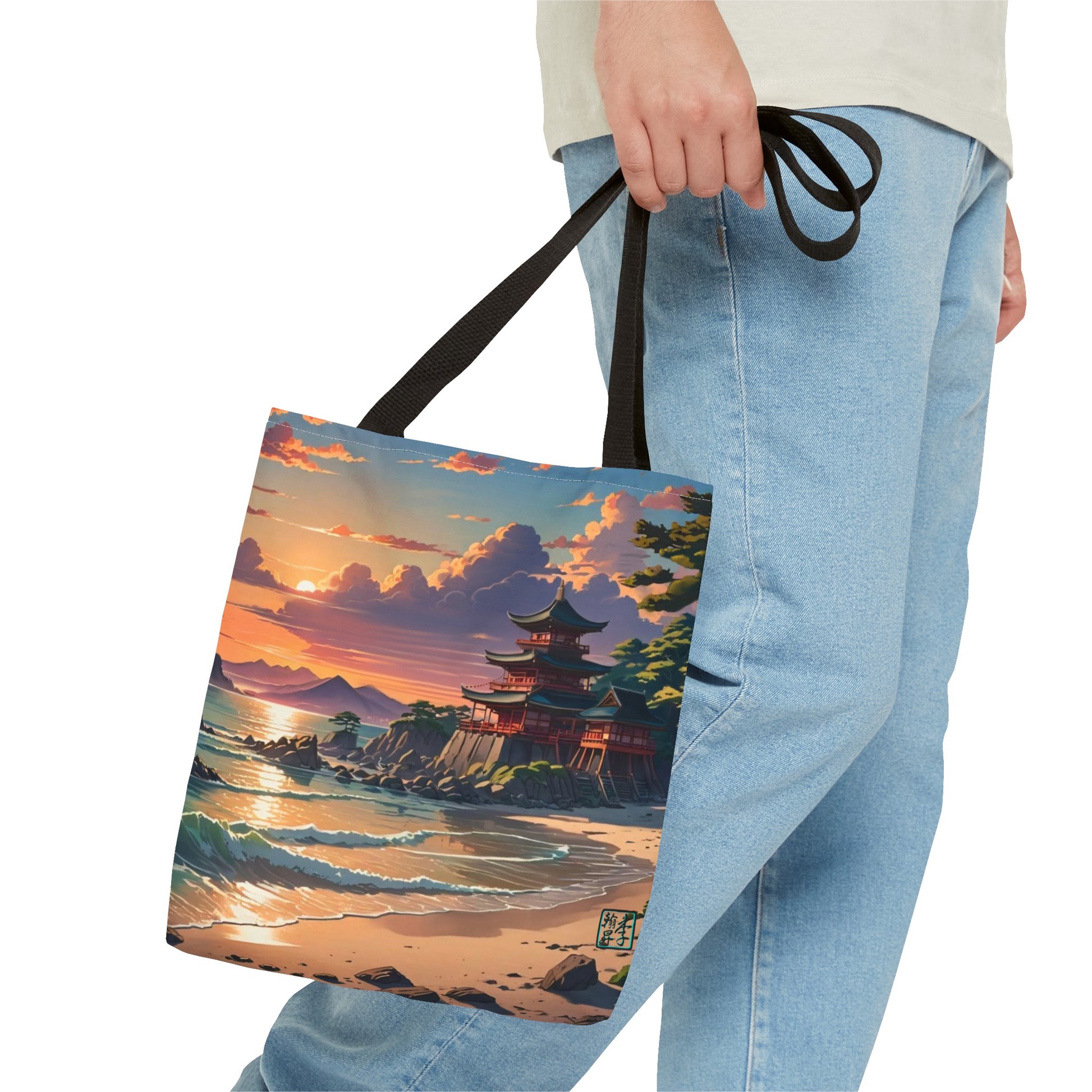 This is the Black 16" x 16" Temple of Peace All-over Print Tote Bag by Lee Hansheng Studios.The illustration shows a setting red/orange sun above clouds,two blue roof,brown/red walled temples on the right on top of the hills,mountains,blue/white waves into sand and a forest to the right.On the bottom right corner is the logo printed in black for the studio and outlined in blue. The image is of a man wearing white tee, light jeans and right hand is holding the tote from waist down.