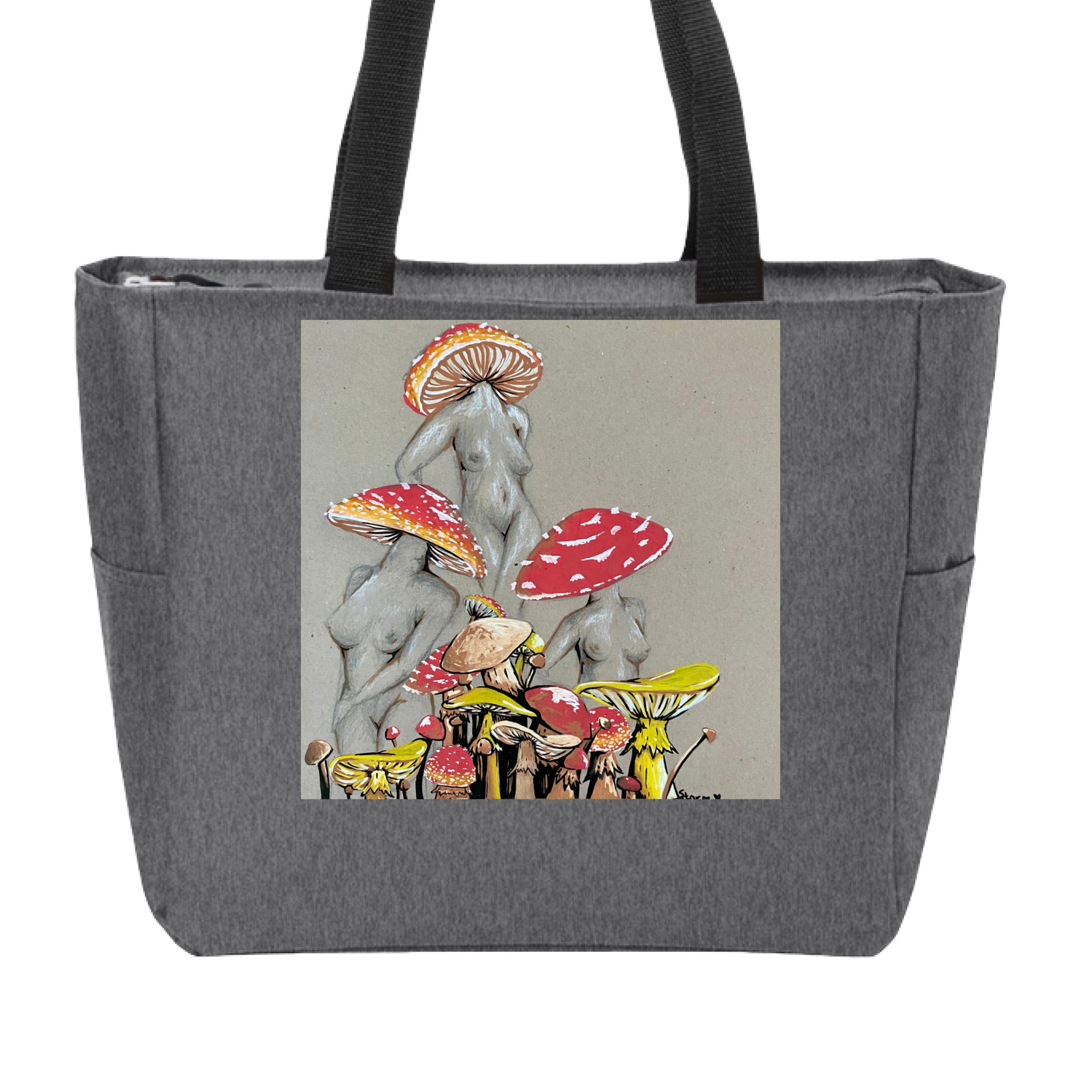 This is the Heather Grey Miss Amanita Zip Tote by Storm Garden Studio. This is showcasing the front. This illustration is on tan/grey background. There are three fusions of female human anatomy and mushroom fungi. Their heads are different styles of mushrooms, bodies are a gray/white outlined in brown. Below are different mushrooms and shapes with a mix of tan, red, white and yellow colors. The tote handles are black. It is against a white background.