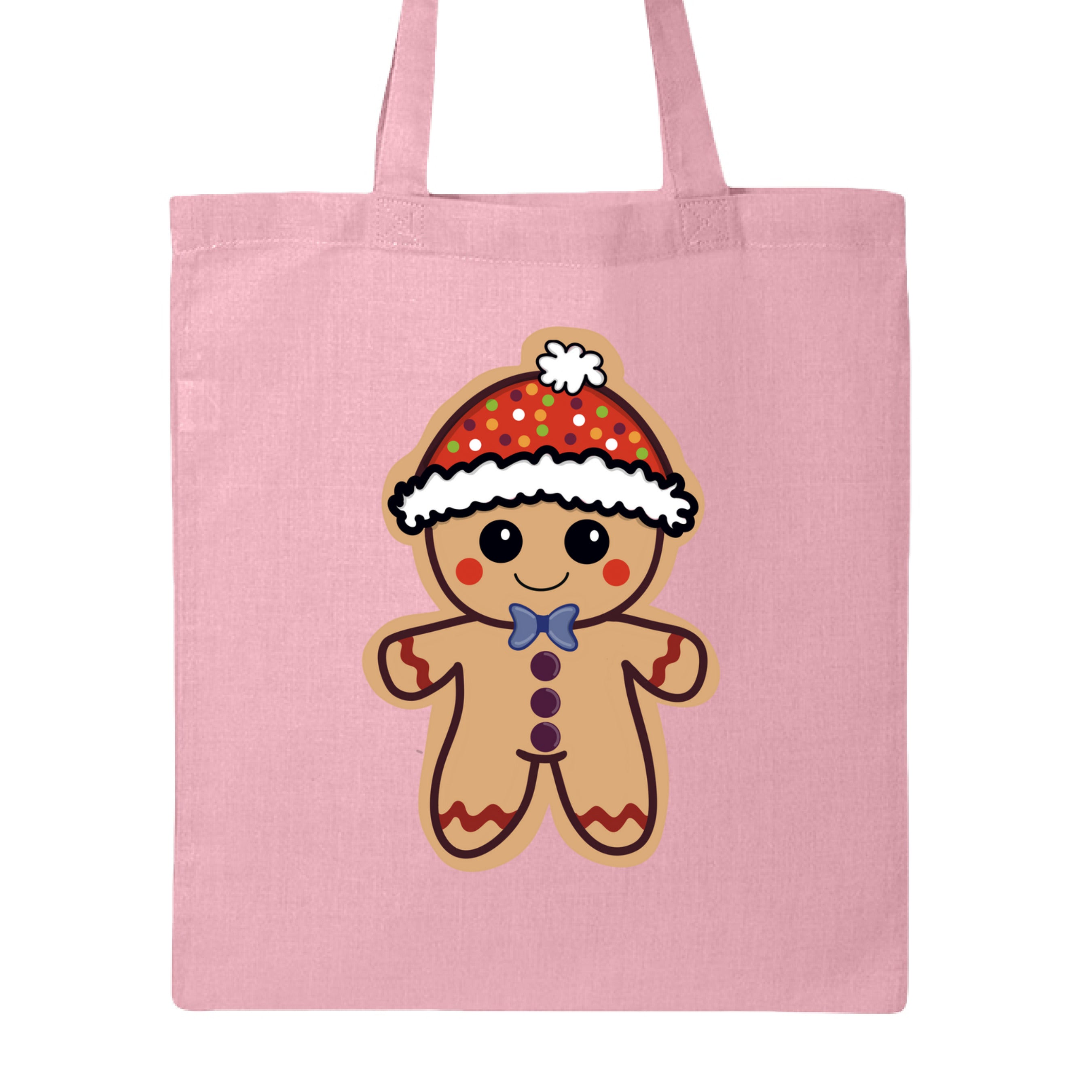 This is the Light Pink Ginger Bread, Ginger Dead Canvas Tote by Dazzle & Daggers Design. This is showcasing the front of the tote. The illustration is of a tan ginger bread who is smiling, red circular cheeks, red zigzags on arm and legs. The gingerbread man is wearing a polka dotted hat with a white puff and lining around the hat. The polka dots are green, blue, purple white and orange. It is against a white background.