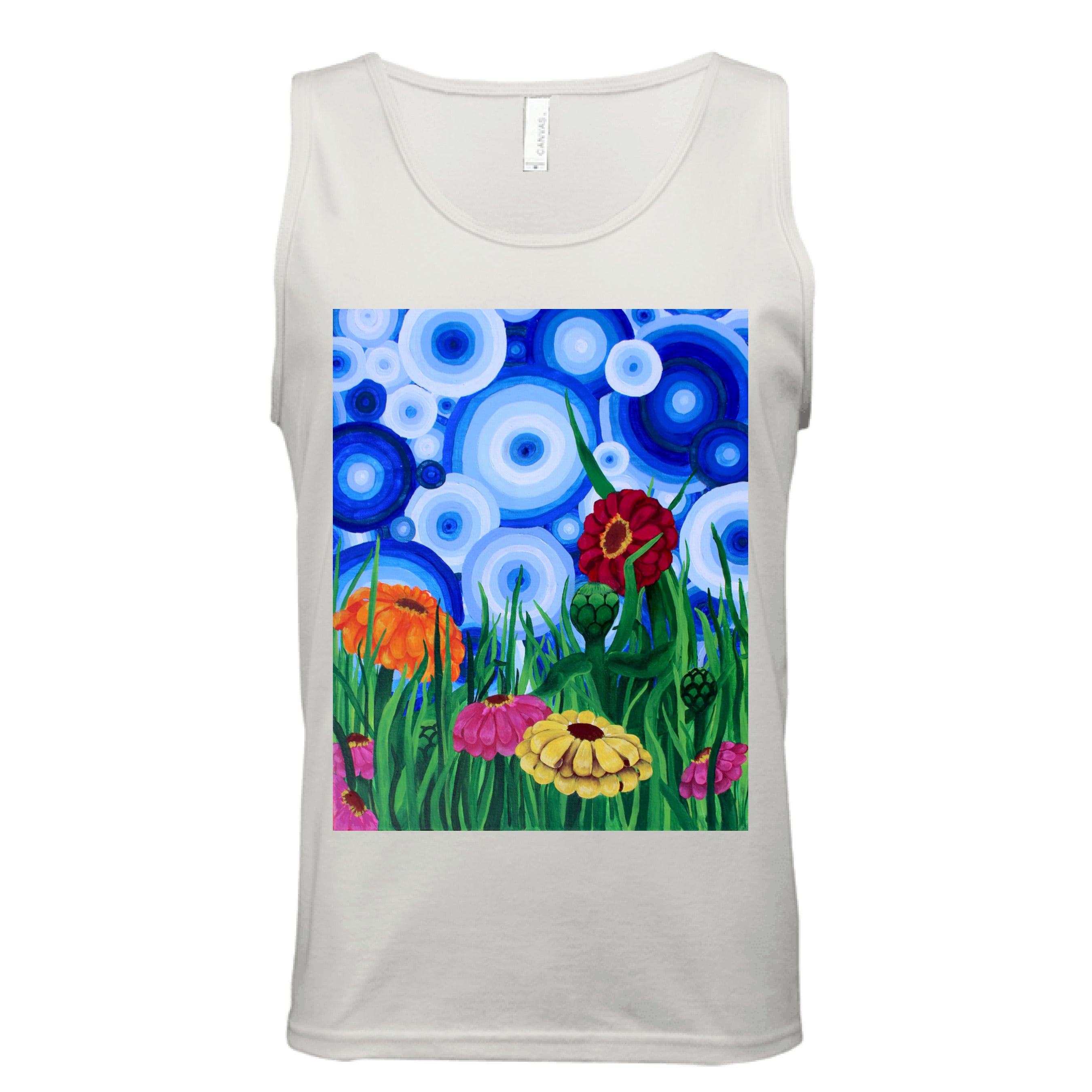This is the Natural Zinnia 2 Tank by Storm Garden Studio. This showcases the front of the tank. The rectangular illustration are bold and color zinnias like red, yellow and orange across tall green grass. The background has many different circles in blue, dark blue and white. The tank is against a white background.