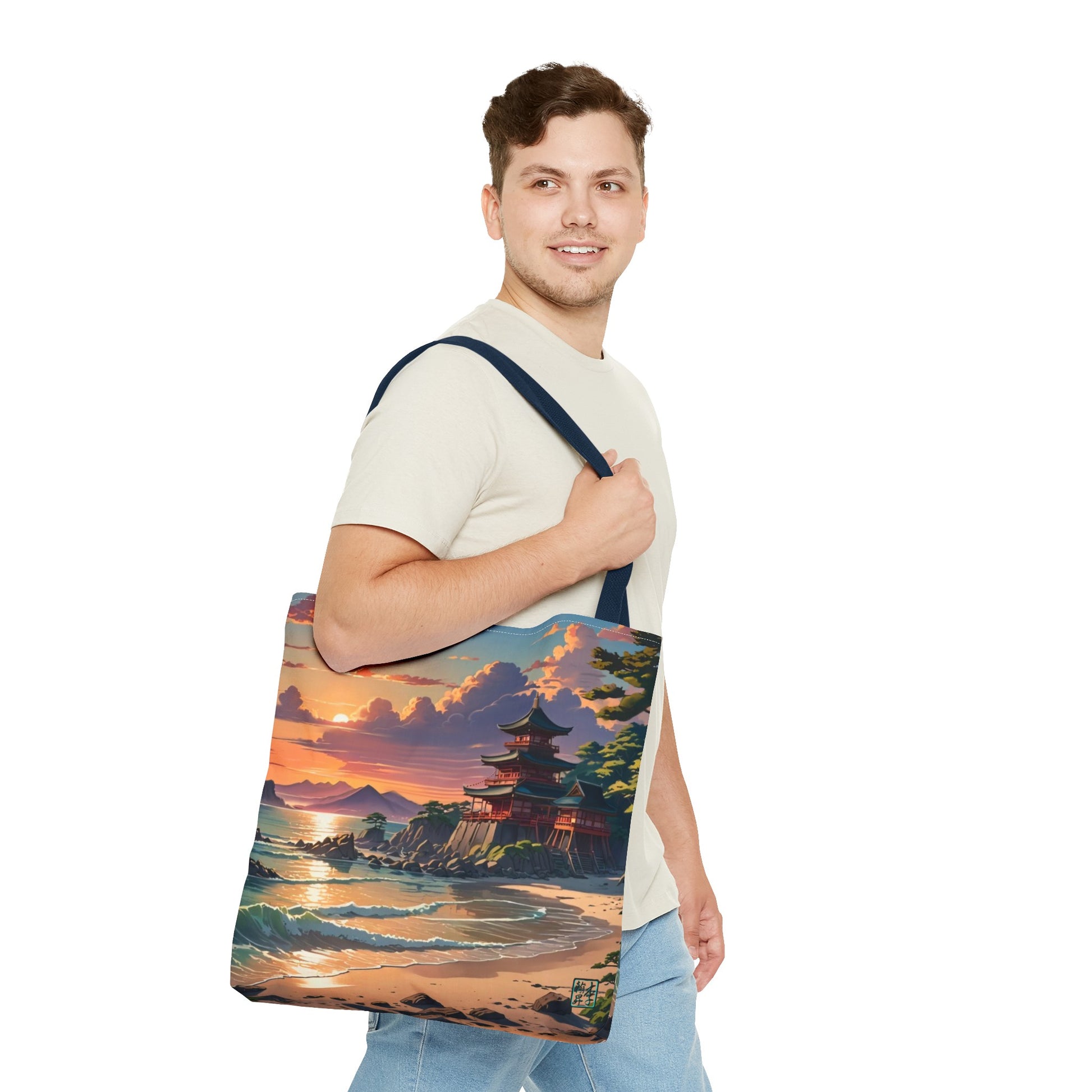 This is the Navy 18" x 18" Temple of Peace All-over Print Tote Bag by Lee Hansheng Studios.The illustration shows a setting red/orange sun above clouds,two blue roof,brown/red walled temples on the right on top of the hills,mountains,blue/white waves into sand and a forest to the right.On the bottom right corner is the logo printed in black for the studio and outlined in blue.A man with a smile, has tote over his shoulder walking right but looking left, wearing white tee, light jeans and hand on the handle.