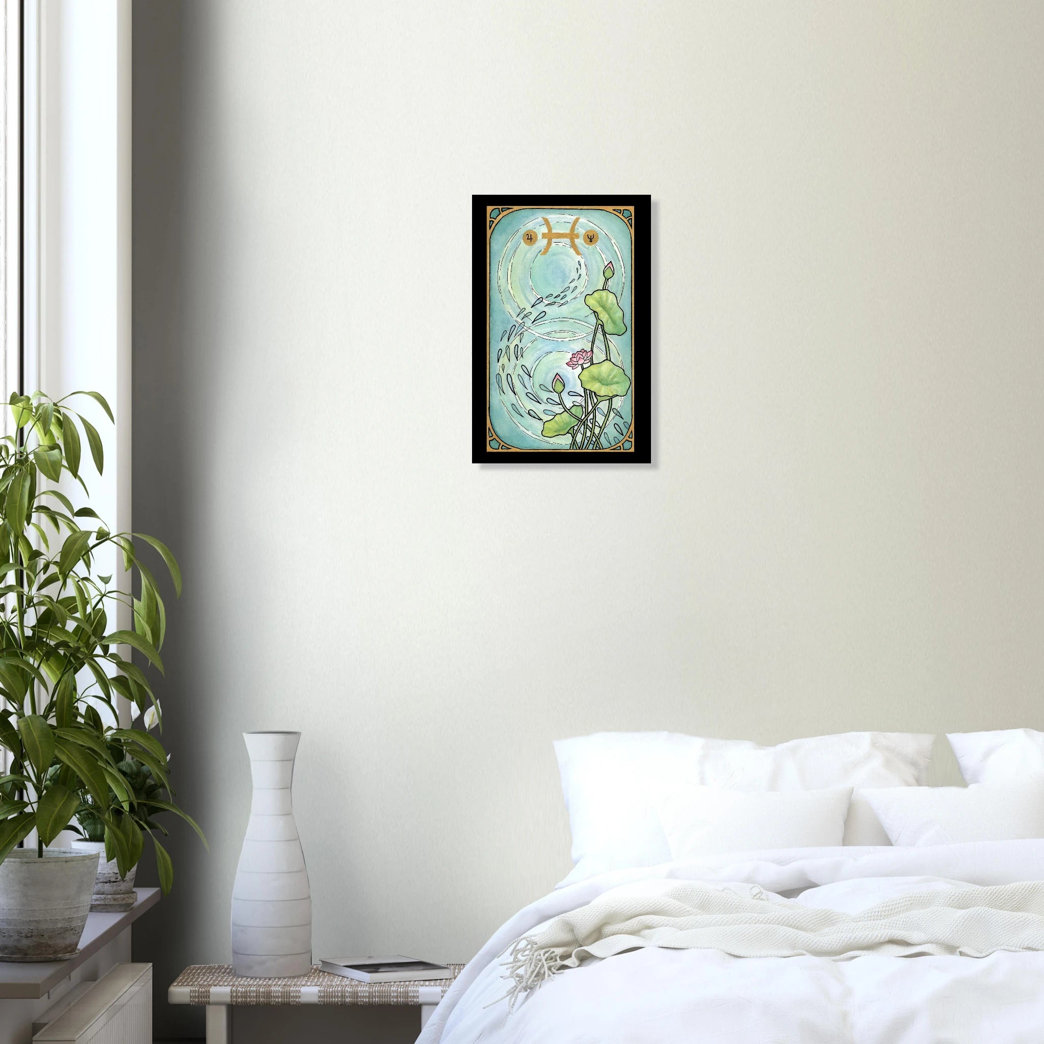 This is the 12" x 18" Pisces Poster by Chris Foster Design. This is a tarot card design and Art Nouveau–inspired design blends the elegance of pink lotus blossoms and water ripples with the celestial symbolism of Jupiter and Neptune. There are water droplets that follow a trail and water ripples in the background. The symbols and intricate frame are gold with a black border.The poster is on a white wall,sheets,pillows on the bed to the right.To the left is a large window with two plants, gradient decor. 