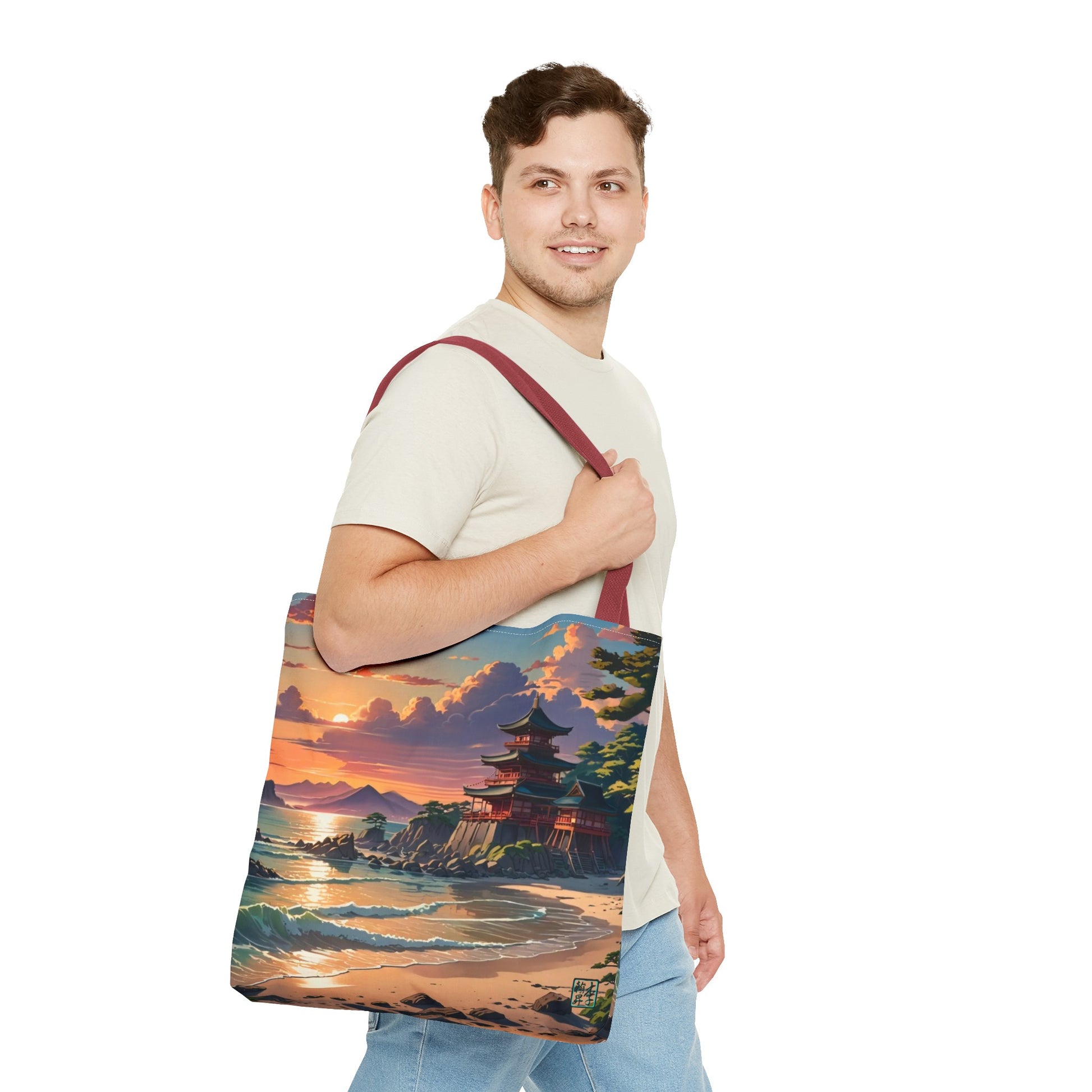 This is the Red 18" x 18" Temple of Peace All-over Print Tote Bag by Lee Hansheng Studios.The illustration shows a setting red/orange sun above clouds,two blue roof,brown/red walled temples on the right on top of the hills,mountains,blue/white waves into sand and a forest to the right.On the bottom right corner is the logo printed in black for the studio and outlined in blue.A man with a smile, has tote over his shoulder walking right but looking left, wearing white tee, light jeans and hand on the handle.
