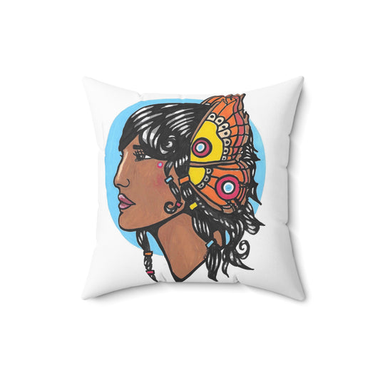 This is a 16" x 16" Warrior Spun Polyester Square Pillow by Storm Garden Studio. This showcases the front of the pillow with a light blue circular background and a darker-skinned woman facing the left. She has light pink lips, high bridged nose and is has a delicare butterfly headpeice that is yellow, red, blue, coloration with black and white intricate lining. Her hair is shiny black with various colors of hair bands throughout her hair.