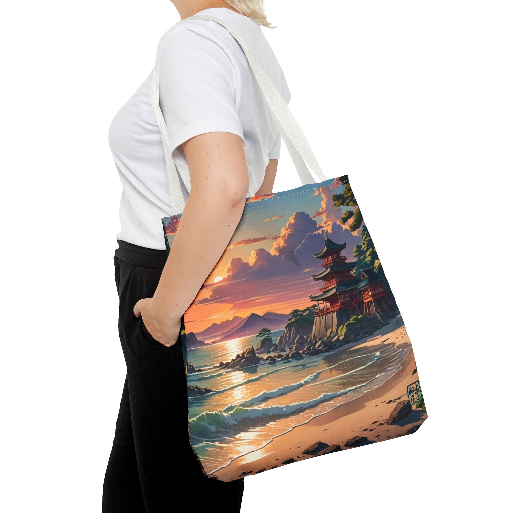 This is the White 18" x 18" Temple of Peace All-over Print Tote Bag by Lee Hansheng Studios.The illustration shows a setting red/orange sun above clouds,two blue roof,brown/red walled temples on the right on top of the hills,mountains,blue/white waves into sand and a forest to the right.On the bottom right corner is the logo printed in black for the studio and outlined in blue.A lady carries the tote from the shoulder,a white tee,blond short hair,her hand in the black pants pocket walking towards the left.