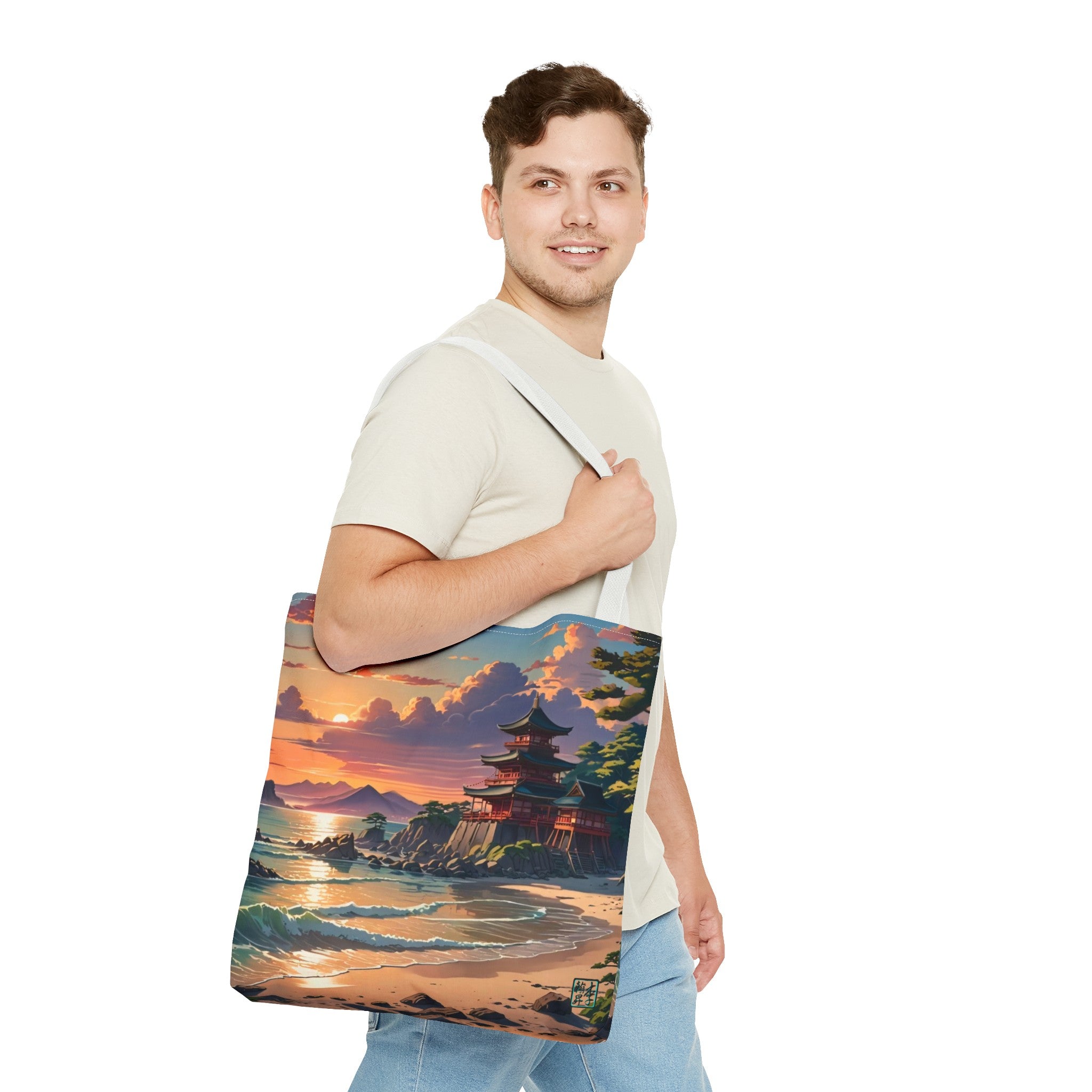 This is the White 18" x 18" Temple of Peace All-over Print Tote Bag by Lee Hansheng Studios.The illustration shows a setting red/orange sun above clouds,two blue roof,brown/red walled temples on the right on top of the hills,mountains,blue/white waves into sand and a forest to the right.On the bottom right corner is the logo printed in black for the studio and outlined in blue.A man with a smile, has tote over his shoulder walking right but looking left,wearing white tee,light jeans and hand on the handle.