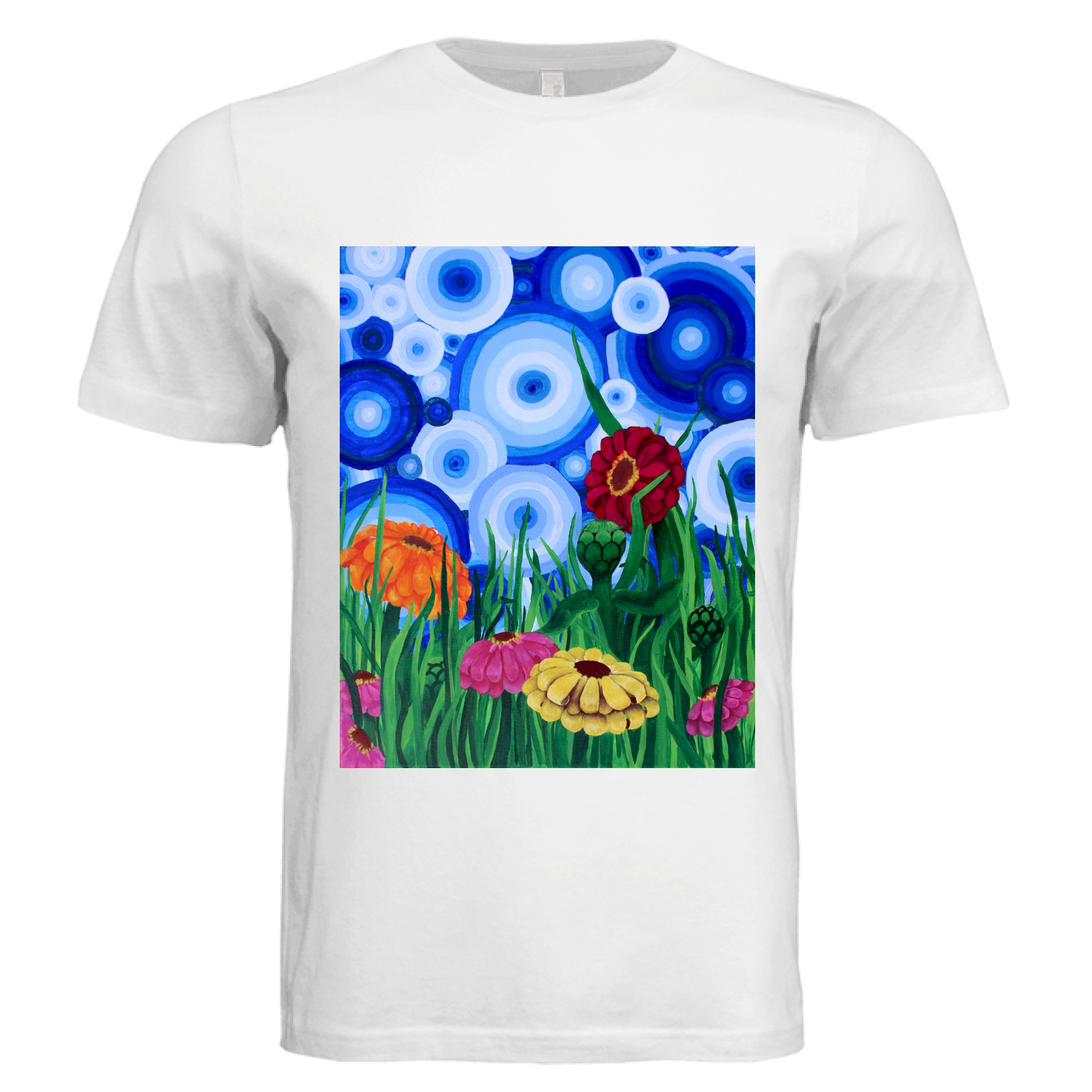 This is the White Zinnia 2 T-Shirt by Storm Garden Studio. This showcases the front of the shirt. The rectangular illustration are bold and color zinnias like red, yellow and orange across tall green grass. The background has many different circles in blue, dark blue and white. The shirt is against a white background.