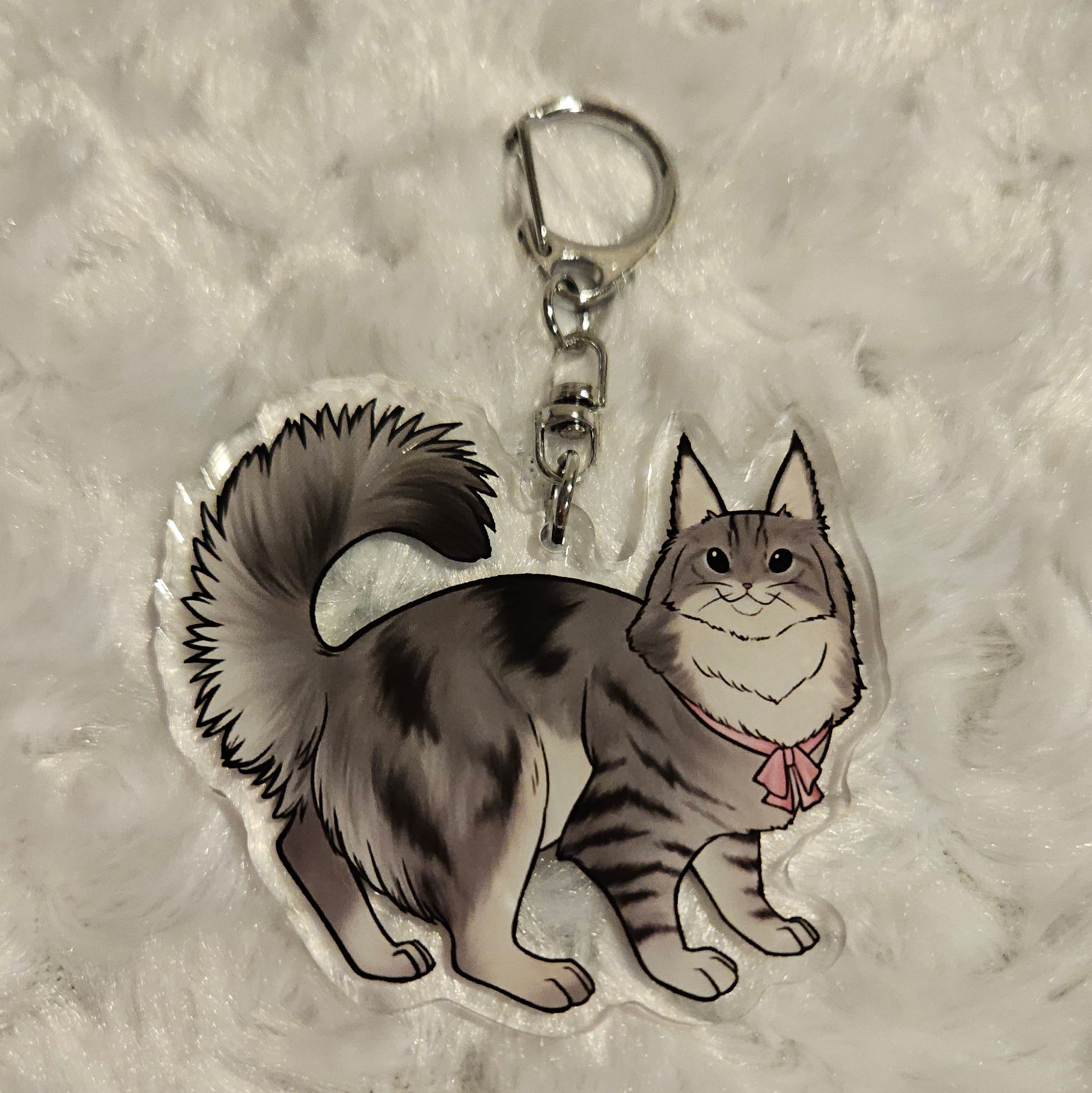 Keychain with a design of a cat on a textured gray background