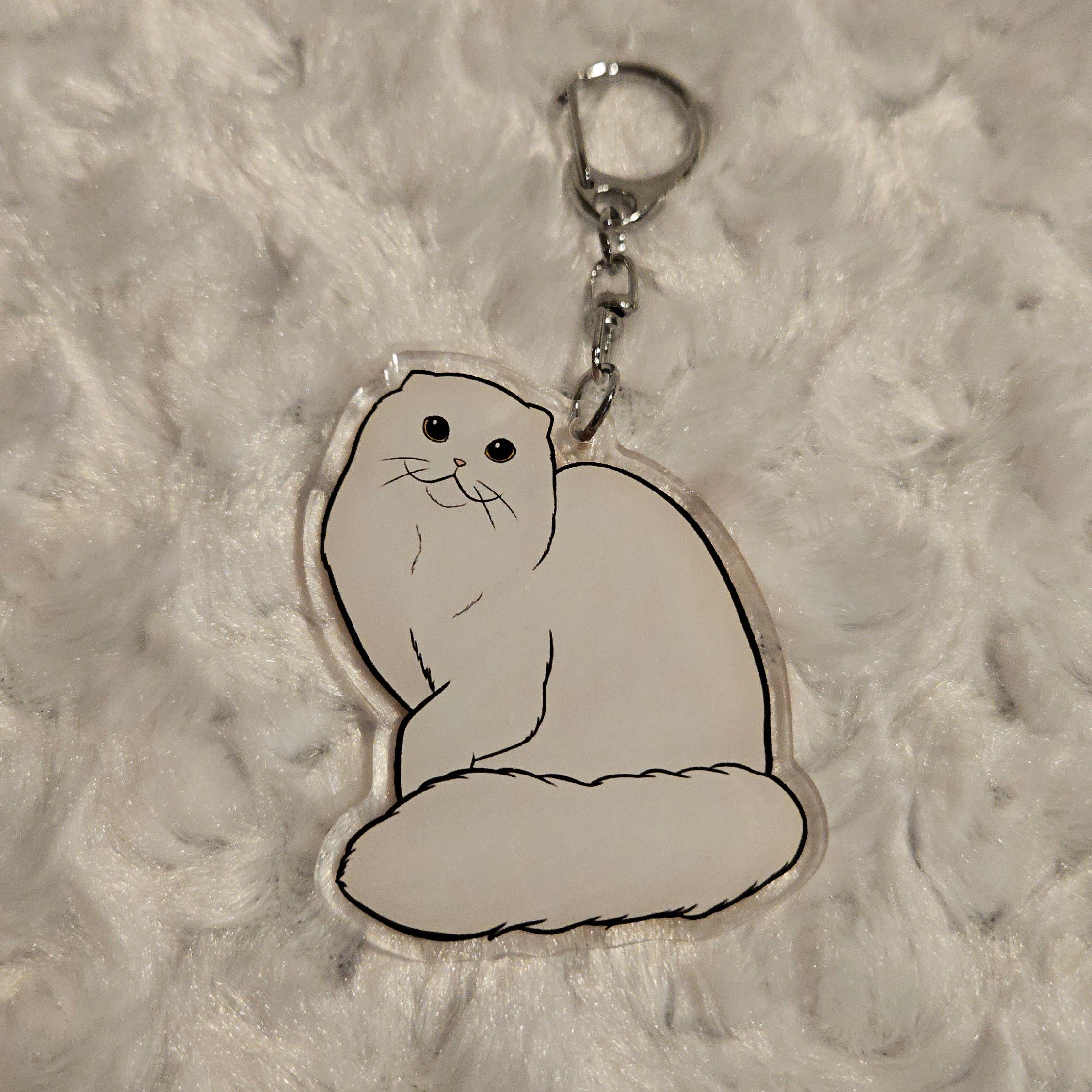 Keychain with a bear design on a textured gray surface