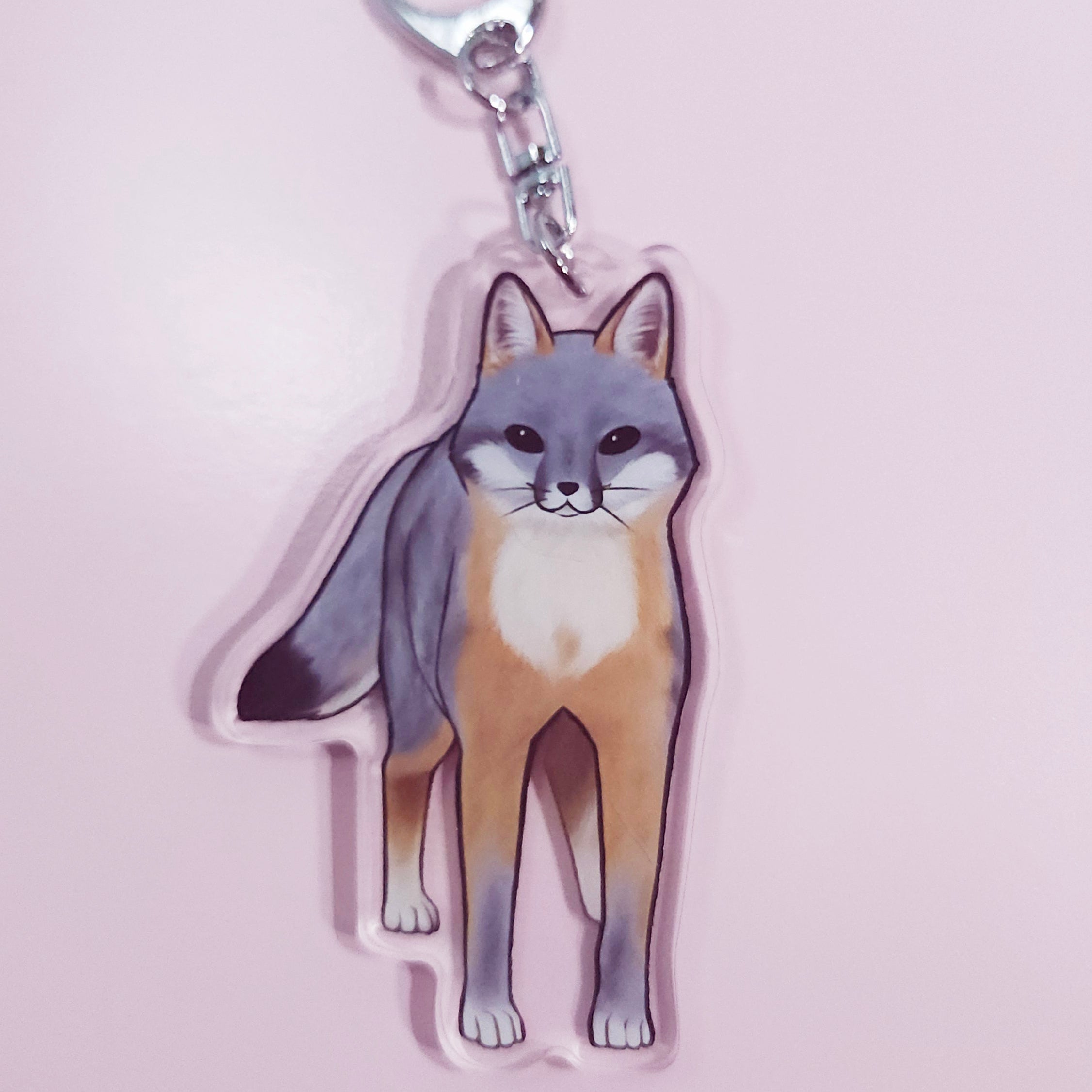 Keychain with a fox design on a pink background