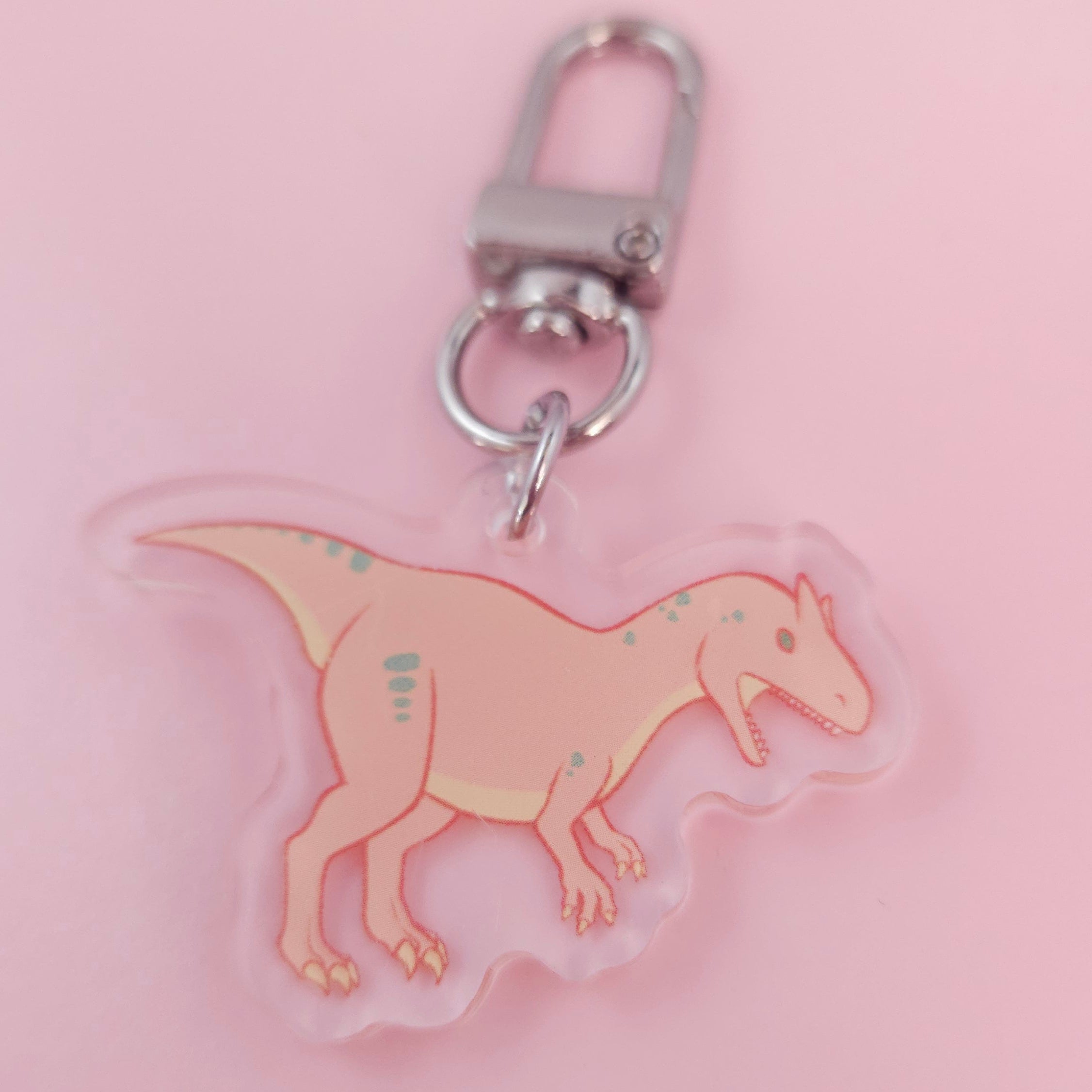 Allosaurus - Dinosaur-shaped keychain on a pink background 1.5"